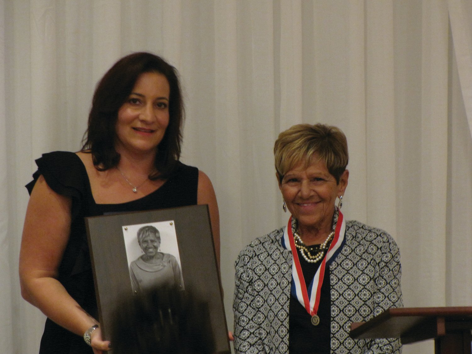 A LASTING HONOR: Doreen Holmes, right, shares a moment with Cranston Superintendent Jeannine Nota-Masse after being inducted into the Cranston Hall of Fame. Holmes